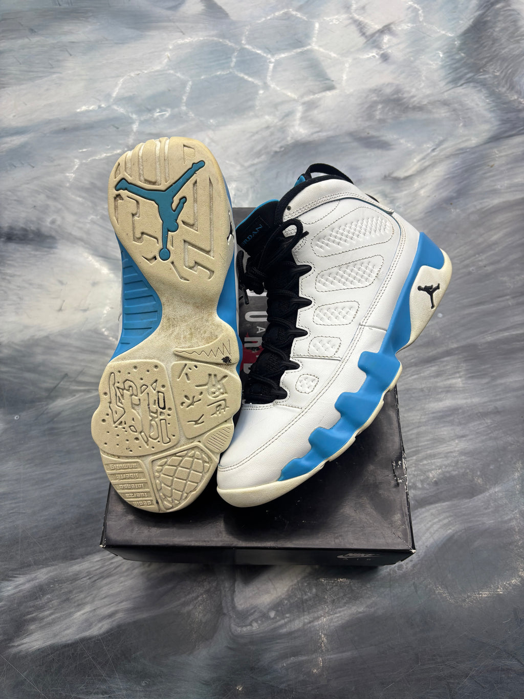 Pre-owned Jordan 9 Retro Powder Blue sneakers, white leather with blue accents, black laces.