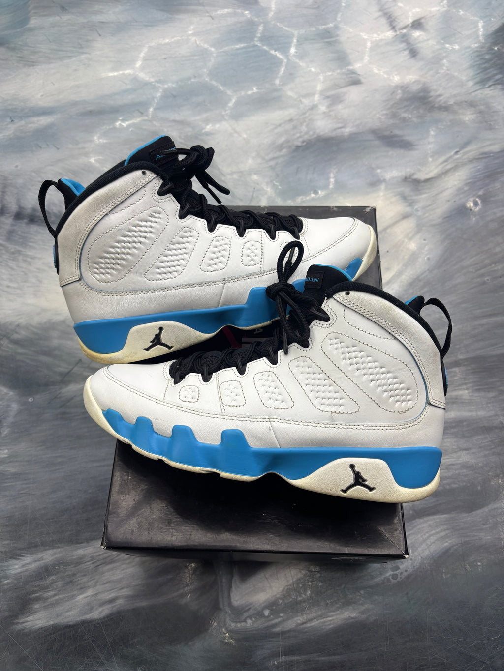 Pre-owned Jordan 9 Retro Powder Blue sneakers, white leather with blue sole accents and black laces.