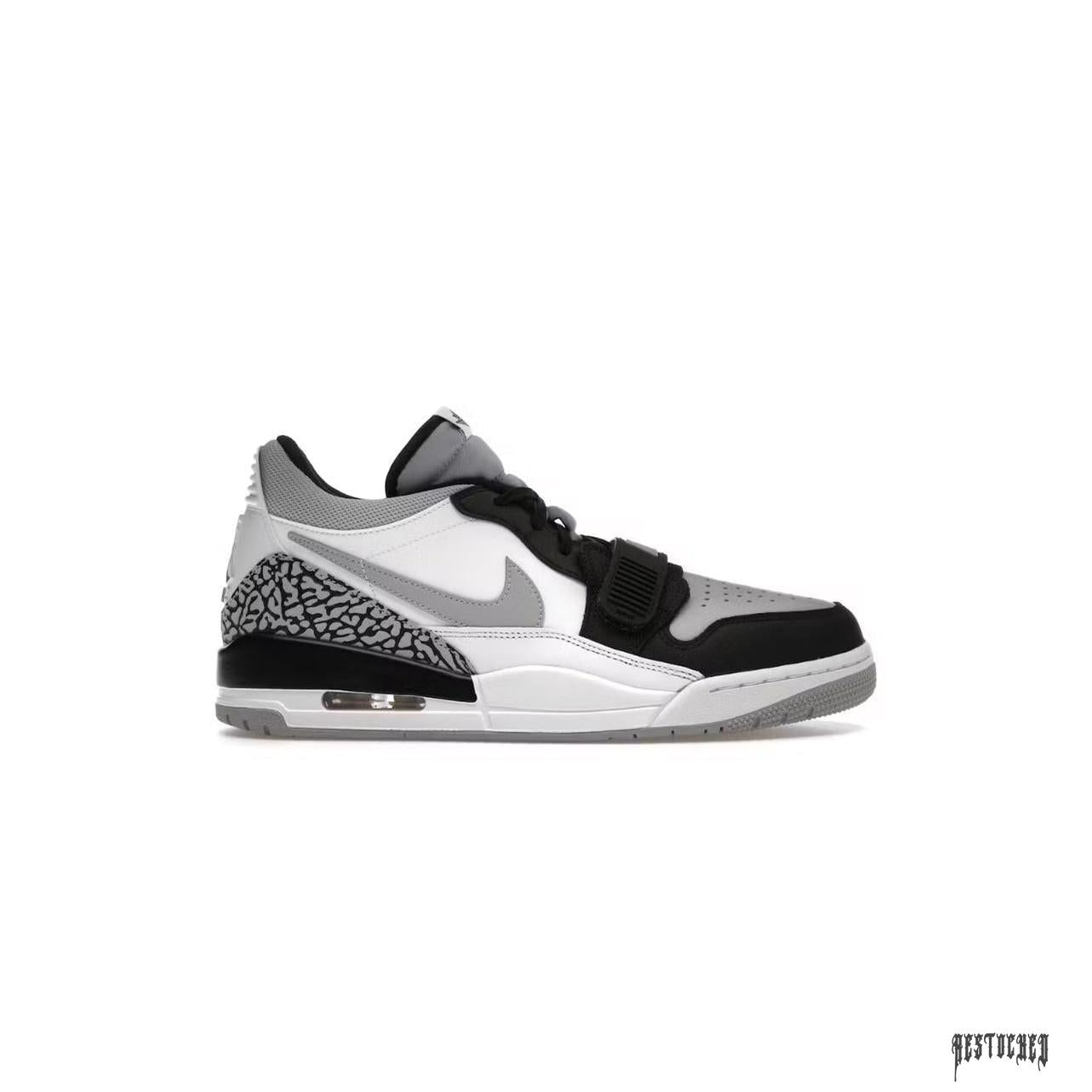 JORDAN LEGACY 312 LOW in light smoke grey, black, and white with elephant print and strap.