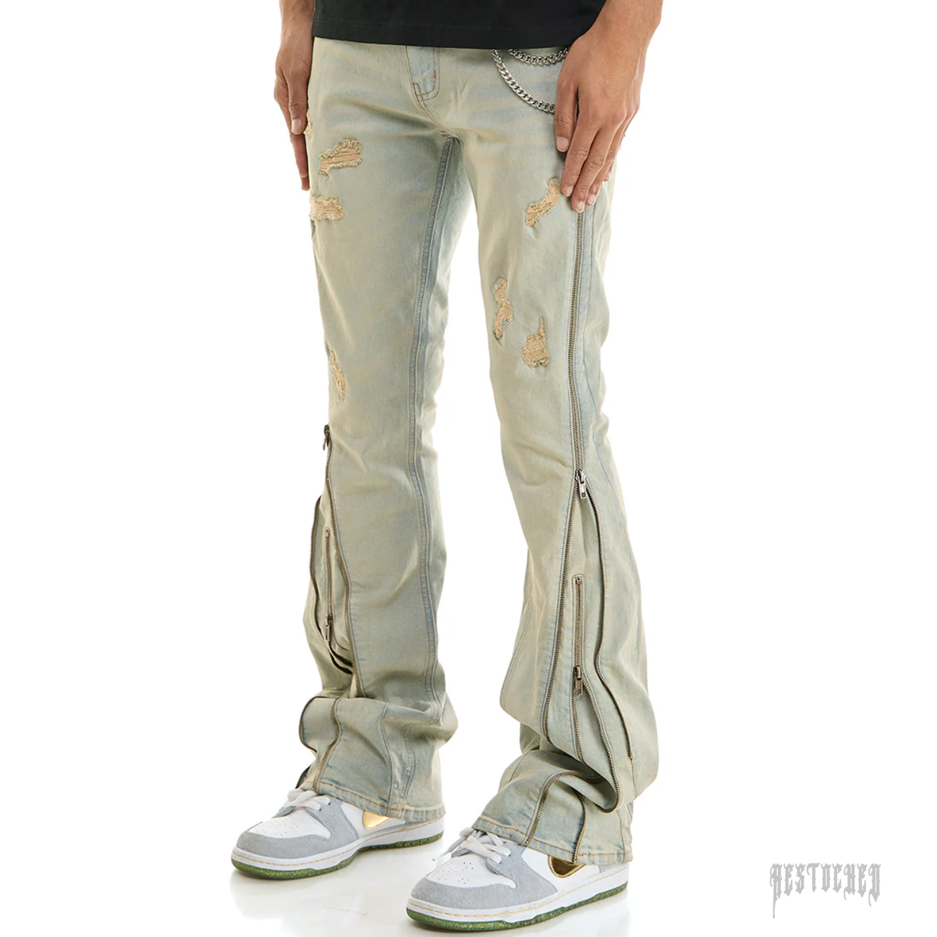 KDNK NEO-ZEPHYR light wash skinny flare jeans with distressed rips and full-length side zippers.