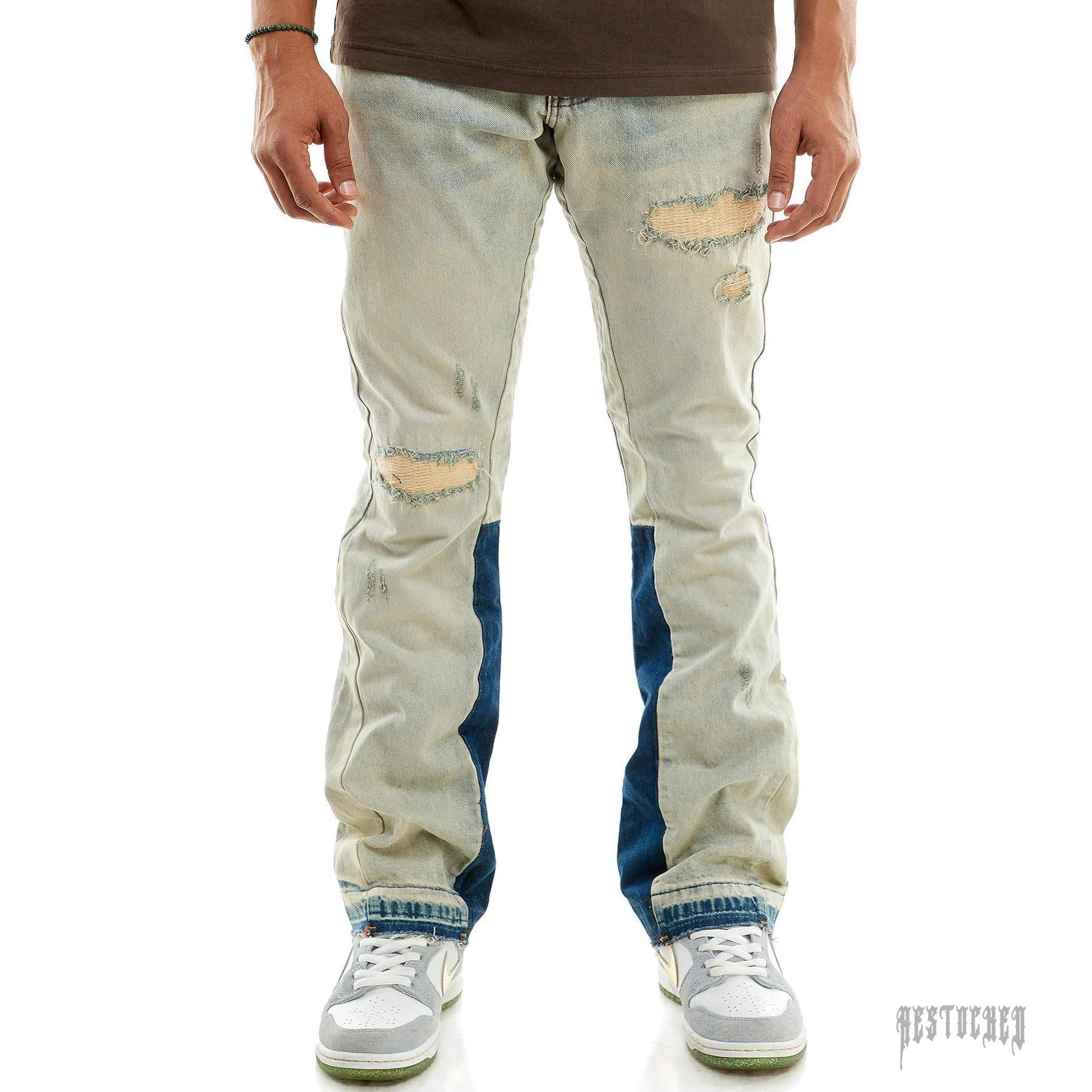 KDNK RIP & REPAIR FLARE JEANS KND4512. Light wash denim with distressed rips and dark blue side panels.