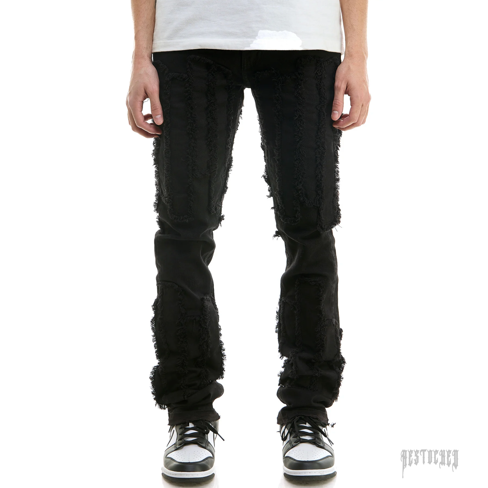 KDNK STACKED BARCHA PANTS KNB3338, black distressed denim with frayed patches.