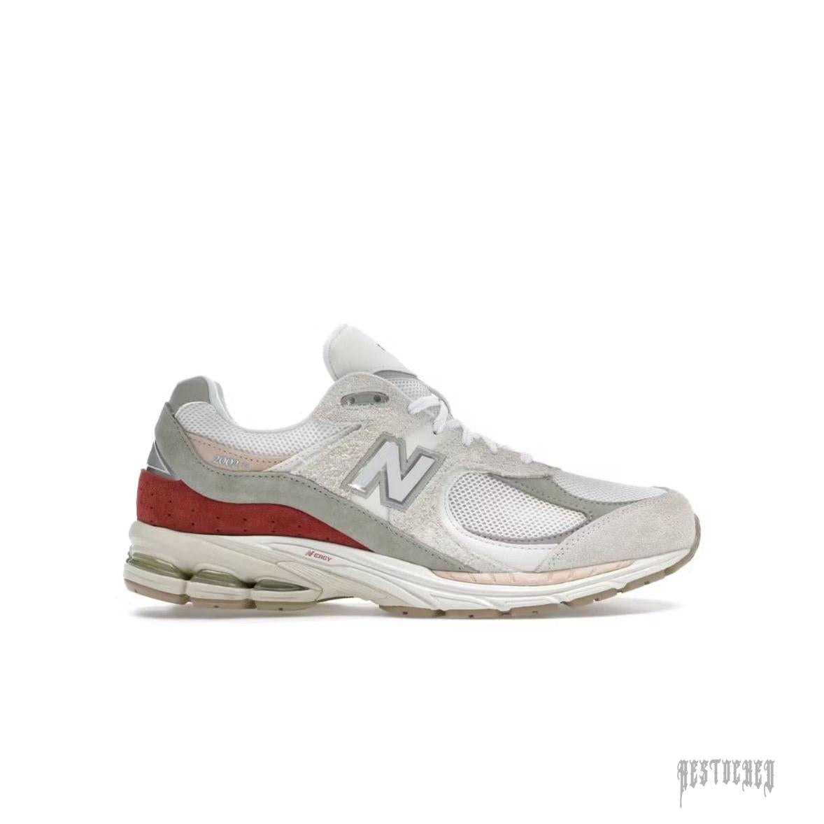 New Balance 2002R Festival sneaker in white, grey, and red with mesh and suede details.