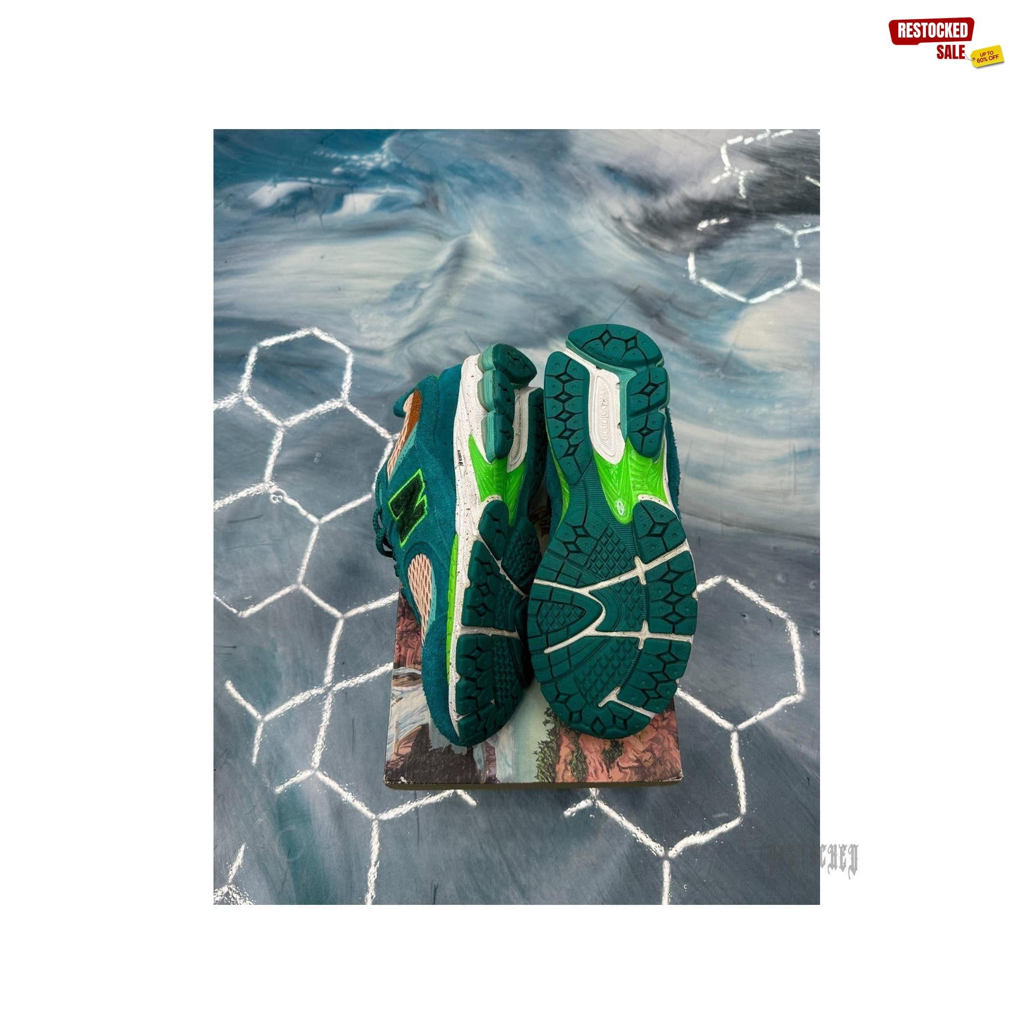 New Balance 2002R Salehe Bembury "Water Be The Guide" sneakers, size 8.5, with teal suede and mesh, orange accents, and green soles.