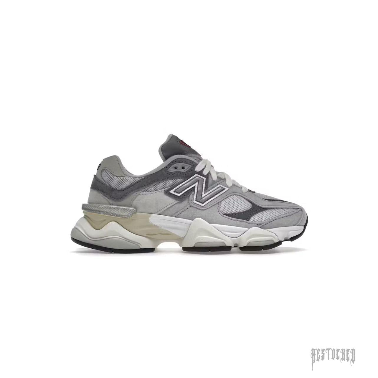 New Balance 9060 Rain Cloud Grey sneaker, featuring mesh and suede upper, chunky sole, and red accents.