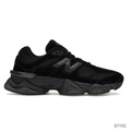 New Balance 9060 Triple Black sneaker with black suede and mesh upper, prominent black N logo, and chunky black sole.