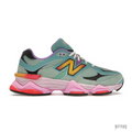 New Balance 9060 Warped Multi-Color sneaker with teal mesh, suede, pink sole, and yellow/orange "N" logo.