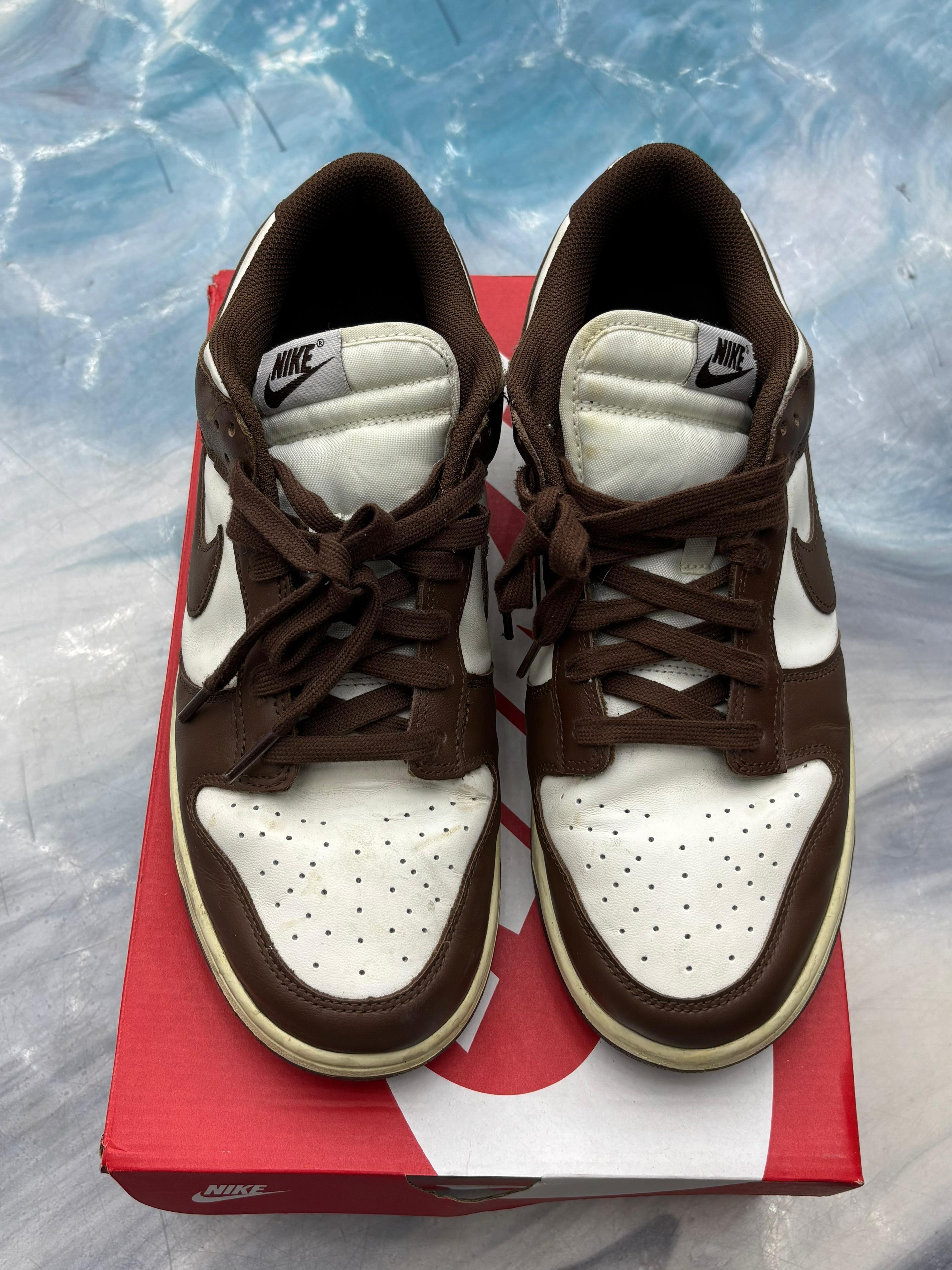 NIKE DUNK LOW CACAO WOW pre-owned sneakers, brown and white leather, size 12W/10.5, on a red box.