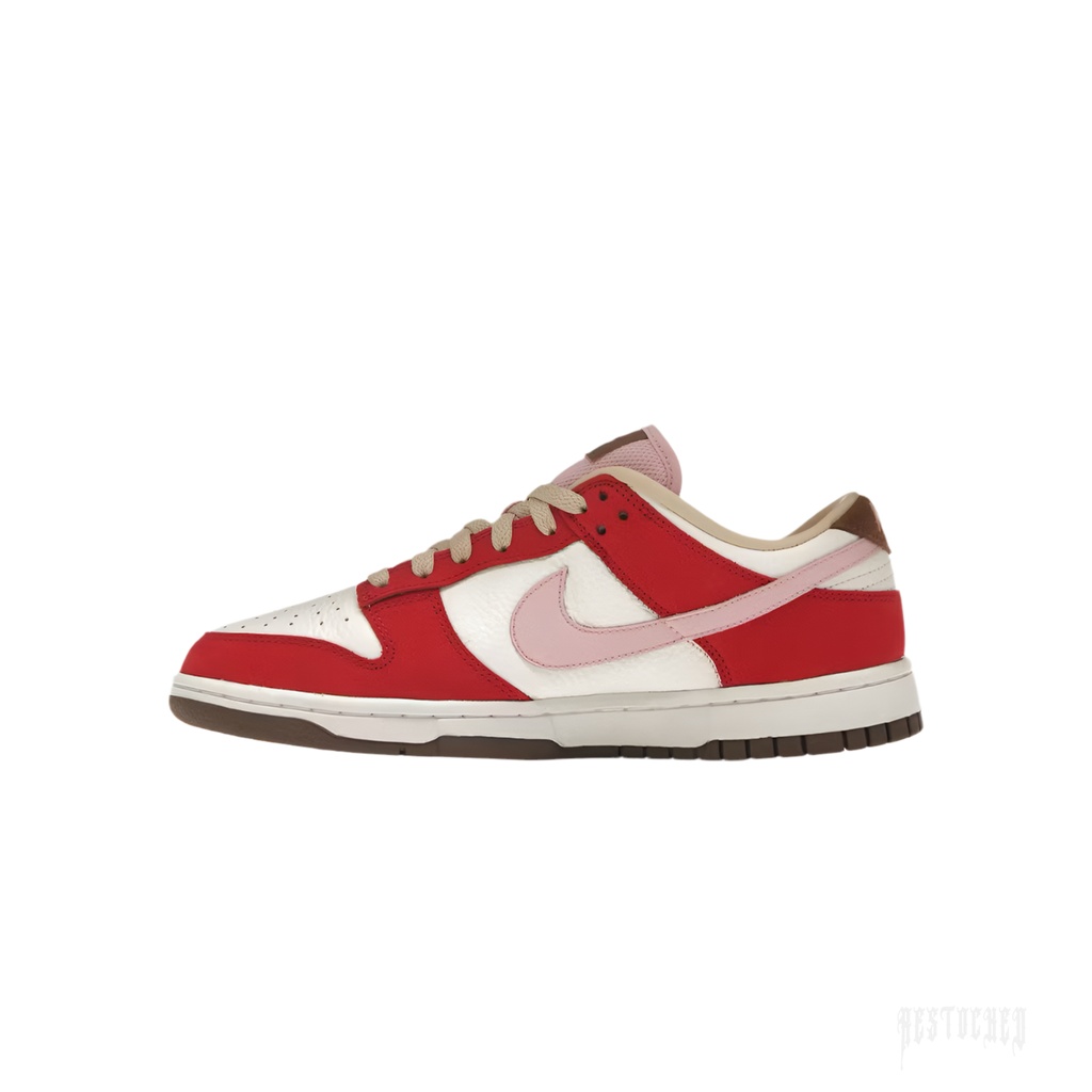 NIKE DUNK LOW PRM BACON women's sneaker with Sail leather, Sport Red suede, Sheen Pink Swoosh, and brown outsole.