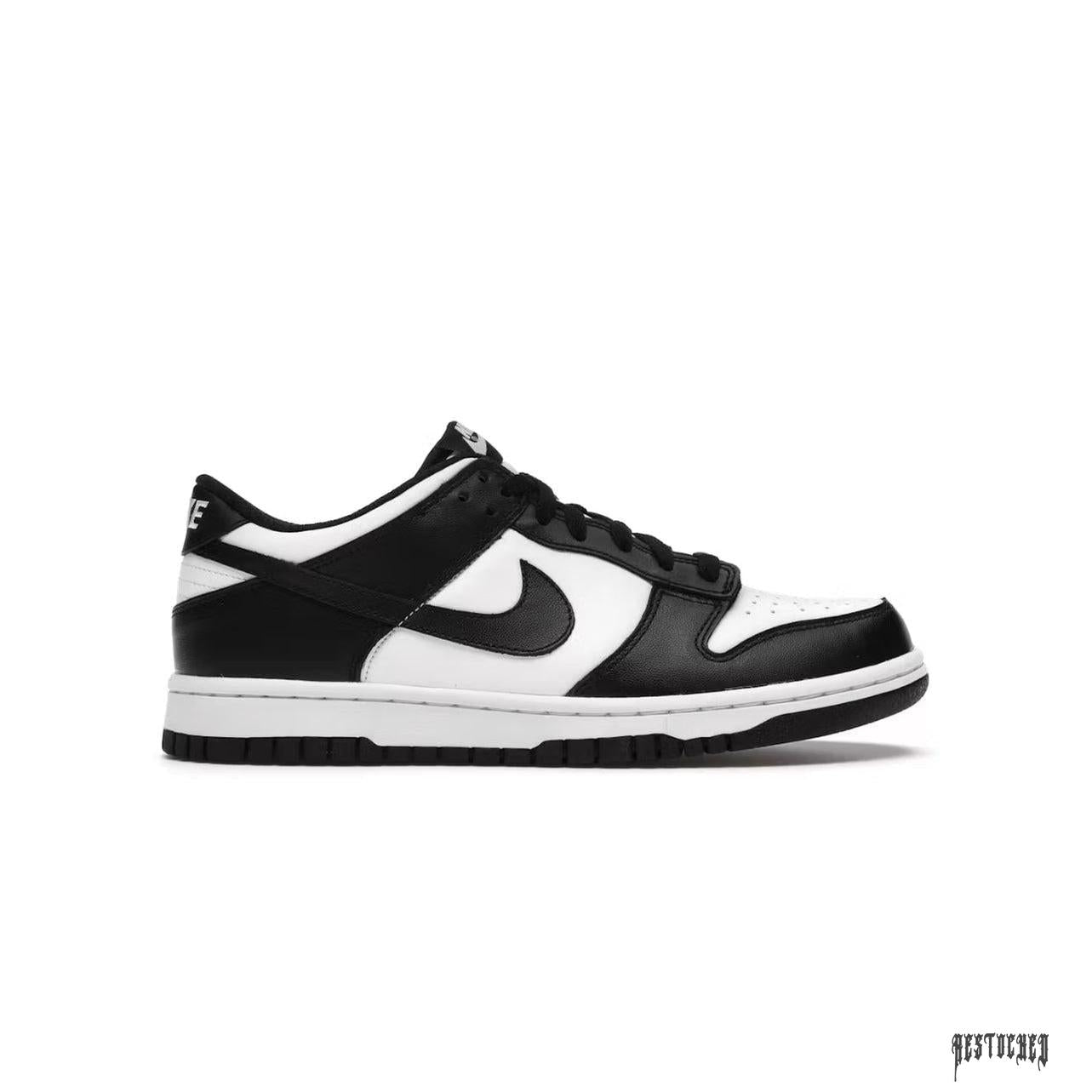 NIKE DUNK LOW RETRO Panda (GS) sneaker with white leather base, black overlays, and black Swoosh.