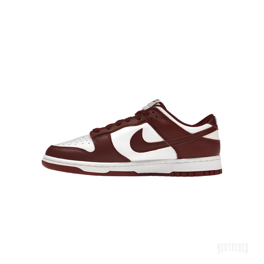 NIKE DUNK LOW TEAM RED sneaker with white leather base, team red overlays, and white swoosh.