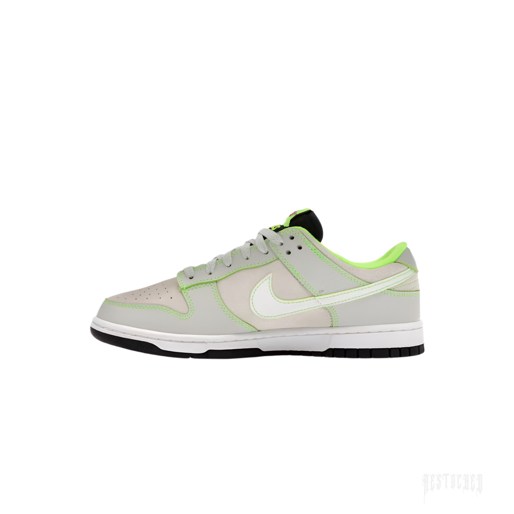 Nike Dunk Low in light grey leather with vibrant neon green accents and white swoosh.