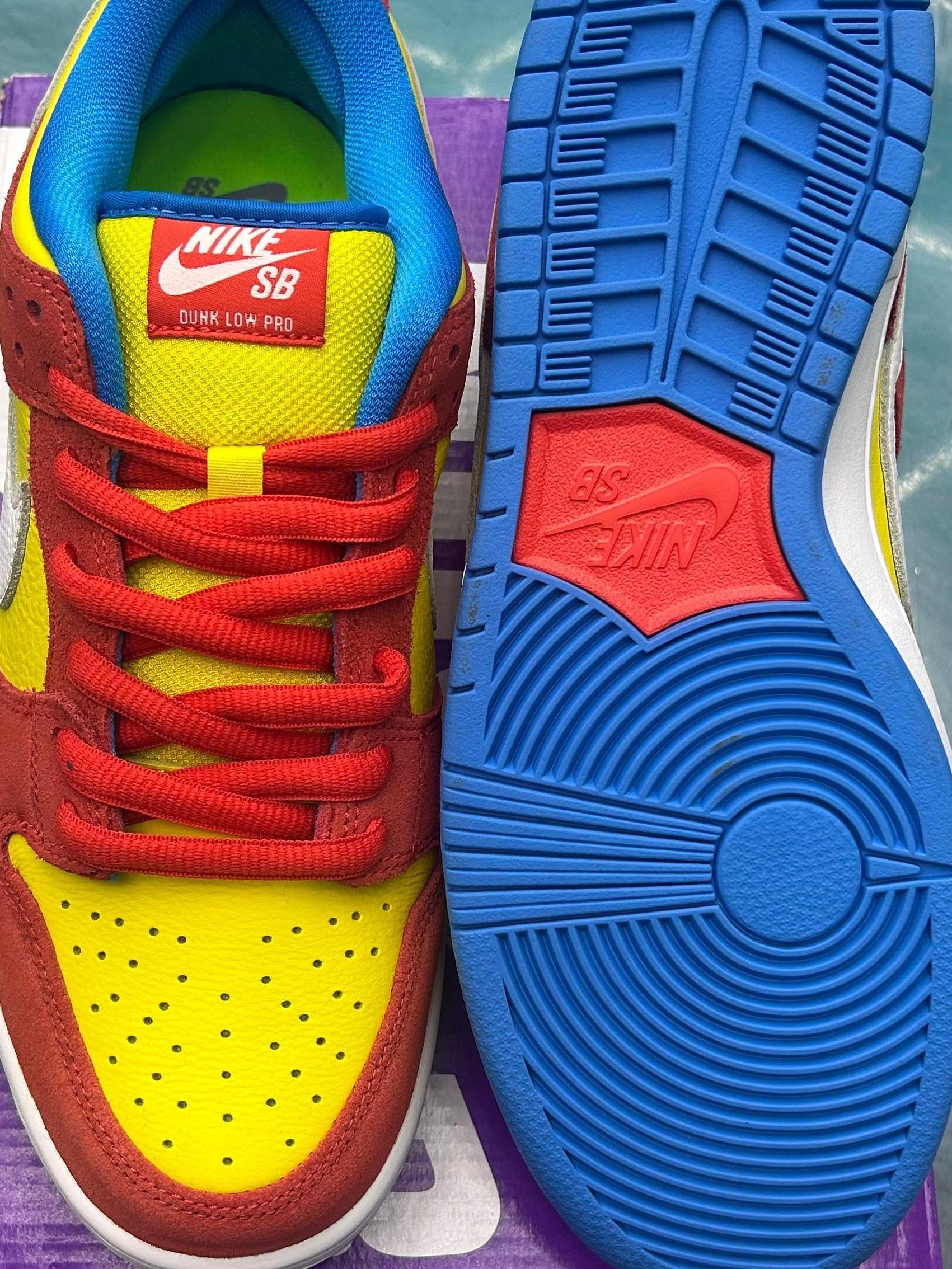 NIKE SB Dunk Low Pro Bart Simpson sneakers, size 10, with yellow leather, red suede, blue laces, and a blue sole.