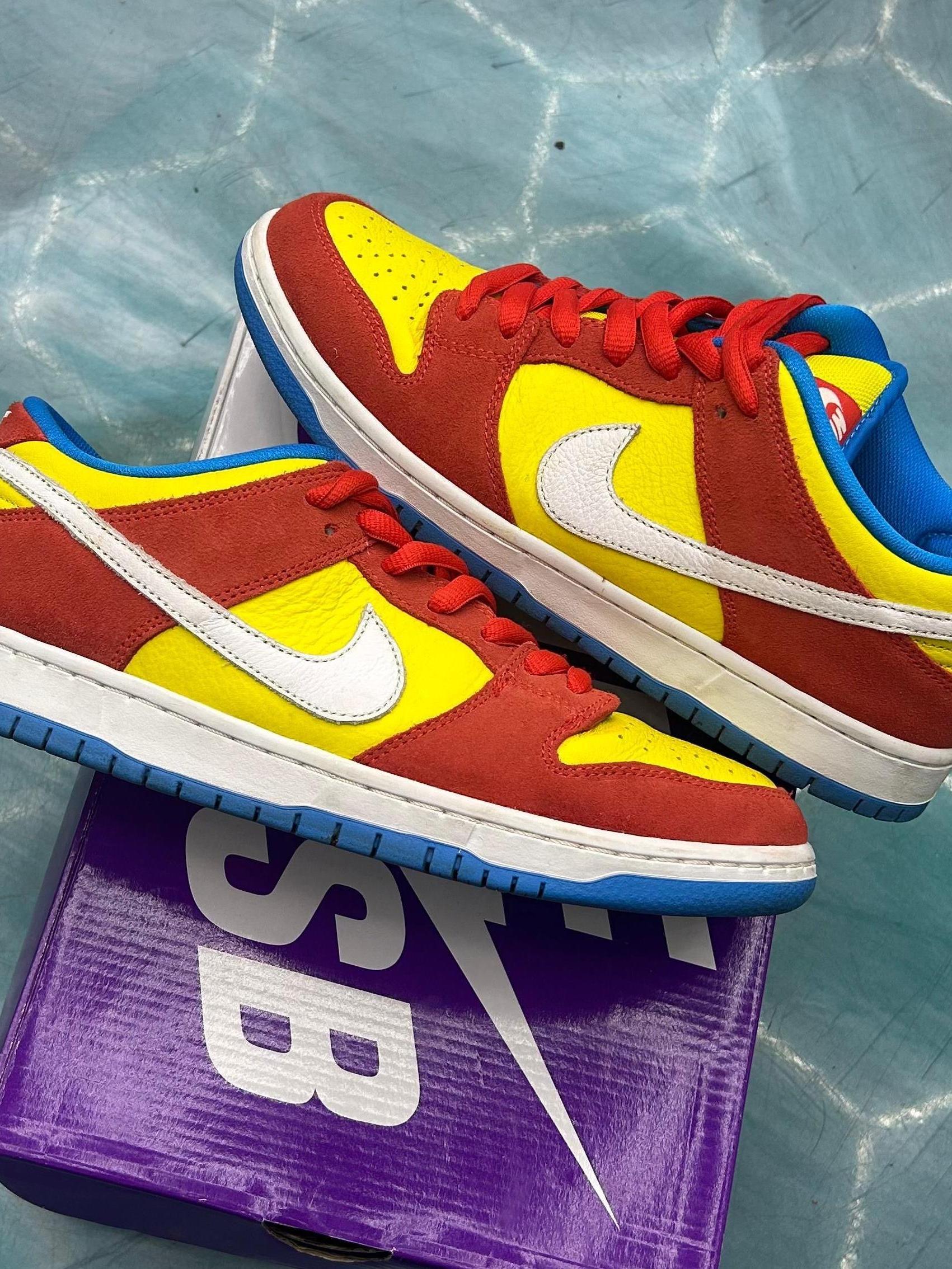 Pre-owned Nike SB Dunk Low Pro Bart Simpson sneakers, size 9.5, in red and yellow with white swoosh and blue accents.