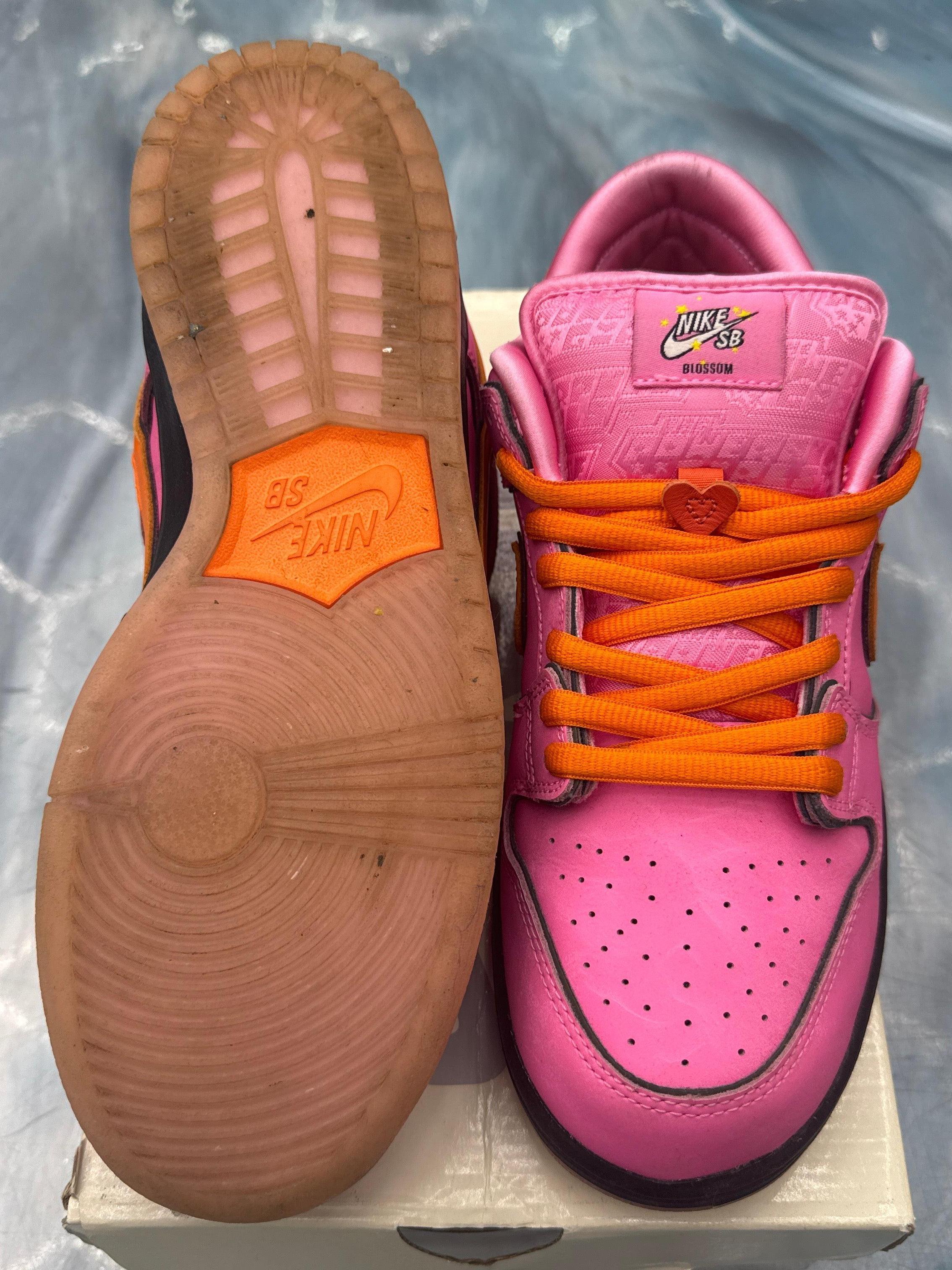 Pre-owned Nike SB Dunk Low Blossom sneakers, pink with orange laces and heart charm, showing sole.