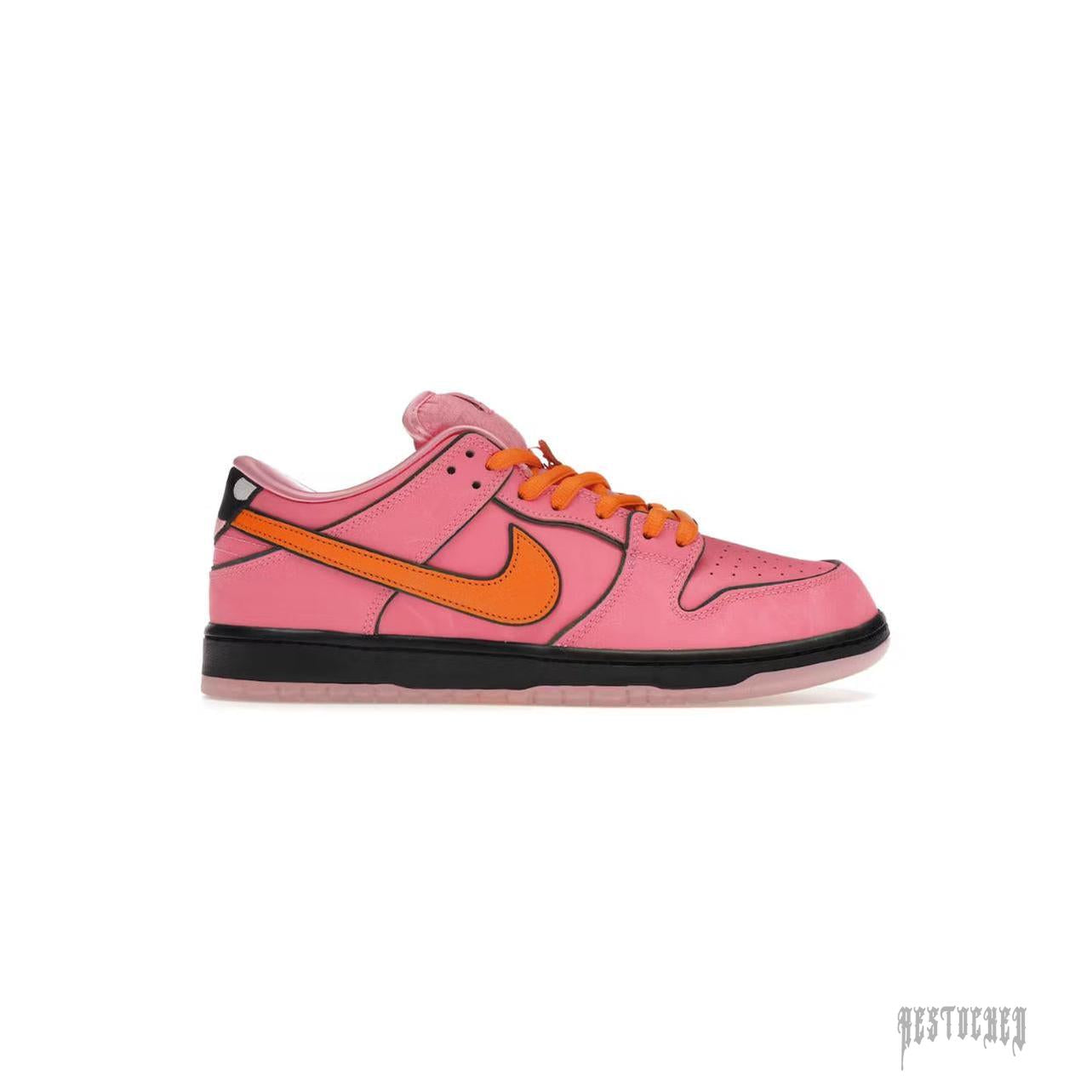 Pink leather Nike SB Dunk Low Blossom sneaker with orange laces and swoosh, black midsole.