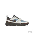 NIKE ZOOM FIELD JAXX Travis Scott Leche Blue sneaker with light blue, cream, and brown accents, black laces, and a velcro strap.