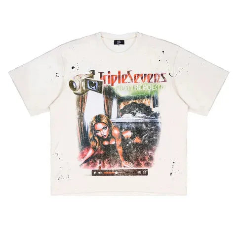 Cream Triple Sevens tee with a vintage camera and woman graphic, distressed details, and black paint splatters.