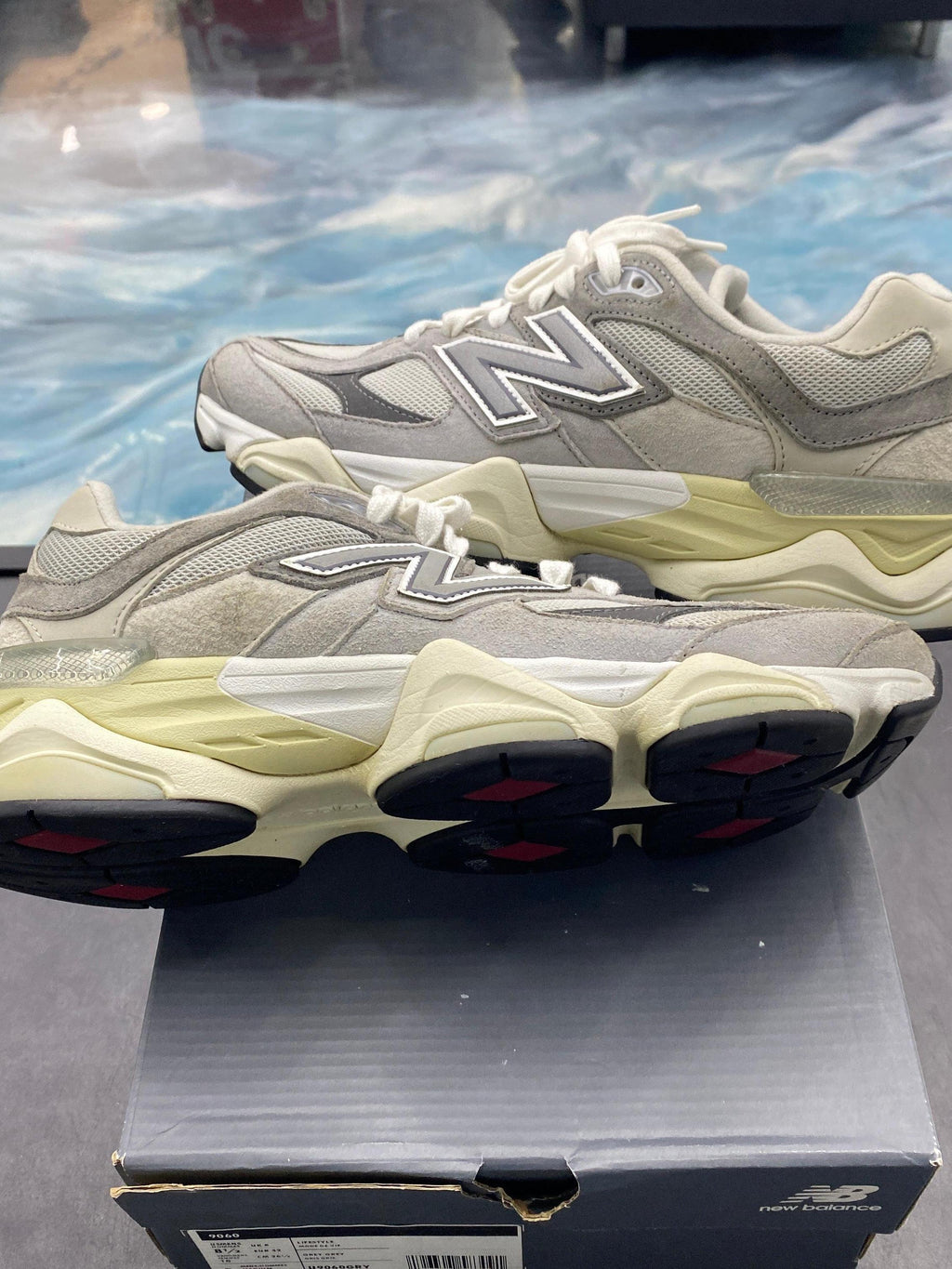 New Balance 9060 Rain Cloud Grey pre-owned sneakers, size 8.5, with mesh and suede upper, cream midsole, and black/red outsole.